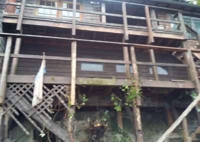 Close-up view of eroded foundation under a house.