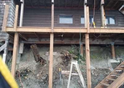 House foundation repair with tools and materials present.