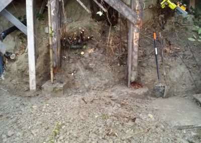 A man working on rebuilding the house foundation.
