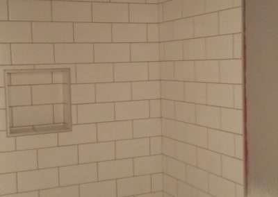 Bathroom featuring a white subway tile shower surround, a bathtub, and a single showerhead.