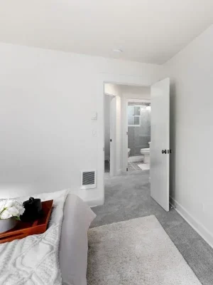 A bright walk-in closet with wire shelving and small windows, featuring ample storage space.