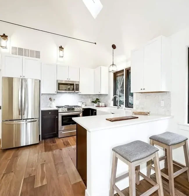Kitchen remodeling Seattle: Bright modern design with white cabinetry, stainless steel appliances, and spacious island.