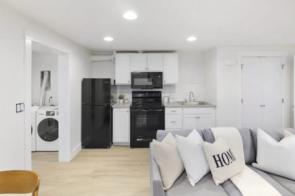 Kitchen backsplash installation with brown mosaic tile border.