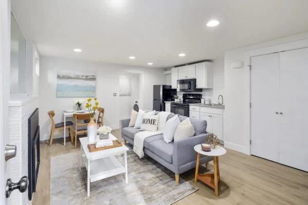 Bright white bathroom featuring subway tile, pedestal sink, wood countertop, and transom windows
