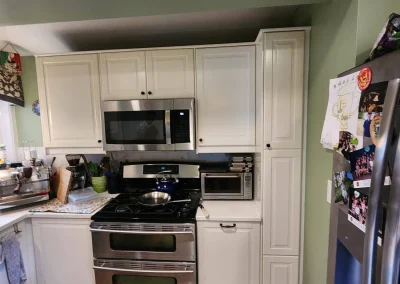 Seattle kitchen remodel showcasing custom white cabinetry, stainless steel double oven, built-in microwave, and modern kitchen upgrades for a high-end transformation.