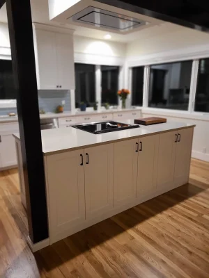 Spacious kitchen island with white cabinetry, quartz countertop, and built-in cooktop in a Seattle home remodel.