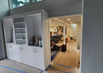 mage Title mercer-island-remodel-built-in-cabinets Alt Text White built-in cabinets under construction in a Mercer Island home remodel with a view into the unfinished kitchen.