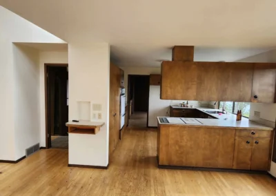 Outdated wood kitchen with enclosed cabinets blocking views before Mercer Island remodel.