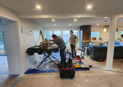 Contractor using a wet saw to cut tile during a kitchen remodel on Mercer Island.