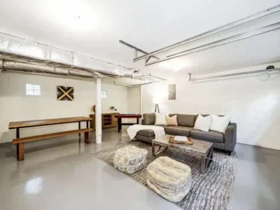 Bellevue-Finished-Basement-Conversion--into-Living-Area Complete conversion from a basement into a living area, with tables, sofa and entertainment settings.