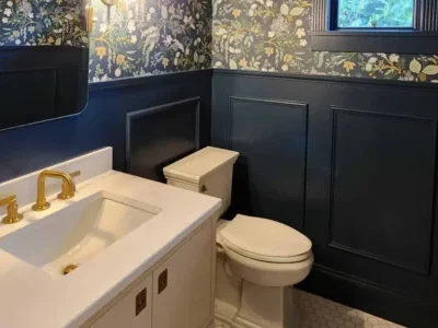 Redmond-custom-Bathroom-Transformation View into a luxury powder room featuring marble hexagon floor tile and deep blue architectural trim.
