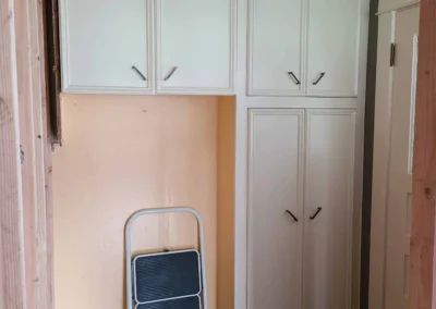 Original Redmond kitchen pantry cabinets with the ceiling partially removed during the remodel demolition