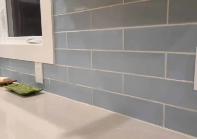 Close-up of handmade blue glass subway tile backsplash in a Redmond kitchen remodel