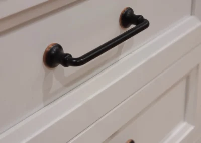 Close-up of oil-rubbed bronze bin pulls on white drawer fronts in a Redmond kitchen remodel
