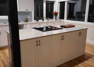 Taupe kitchen island with cooktop and ample cabinet storage in a Redmond kitchen remodel