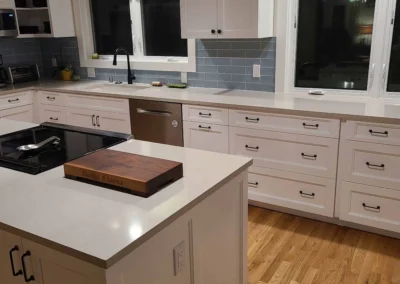 White cabinets with oil-rubbed bronze hardware and quartz countertops in a Redmond kitchen remodel
