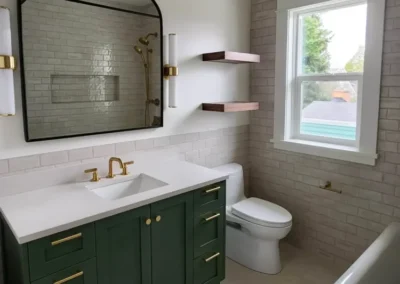 Kirkland bathroom remodel with a green vanity and arched mirror.