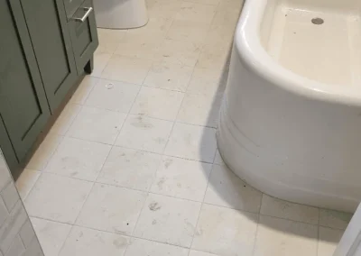 Kirkland bathroom remodel with large-format floor tile and a green vanity.