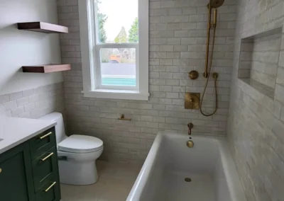 Kirkland bathroom remodel with a freestanding soaking tub and aged brass shower system.