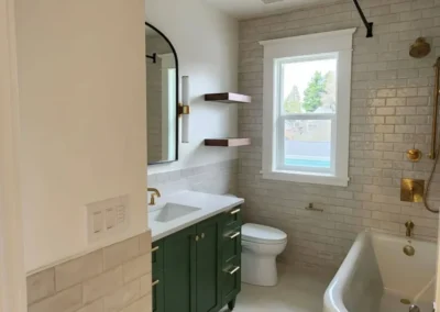 Kirkland bathroom remodel featuring a green vanity and walnut floating shelves.